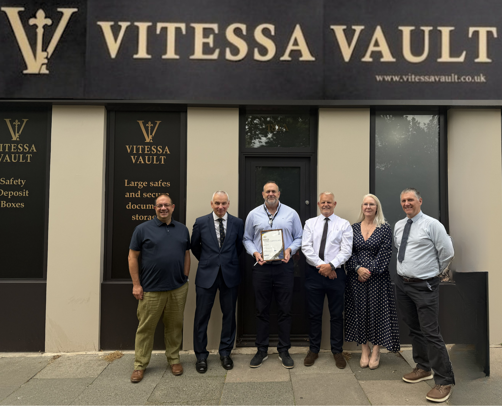 Vitessa Vault team and Police CPI representatives outside Vitessa Vault with the Gold Award certificate